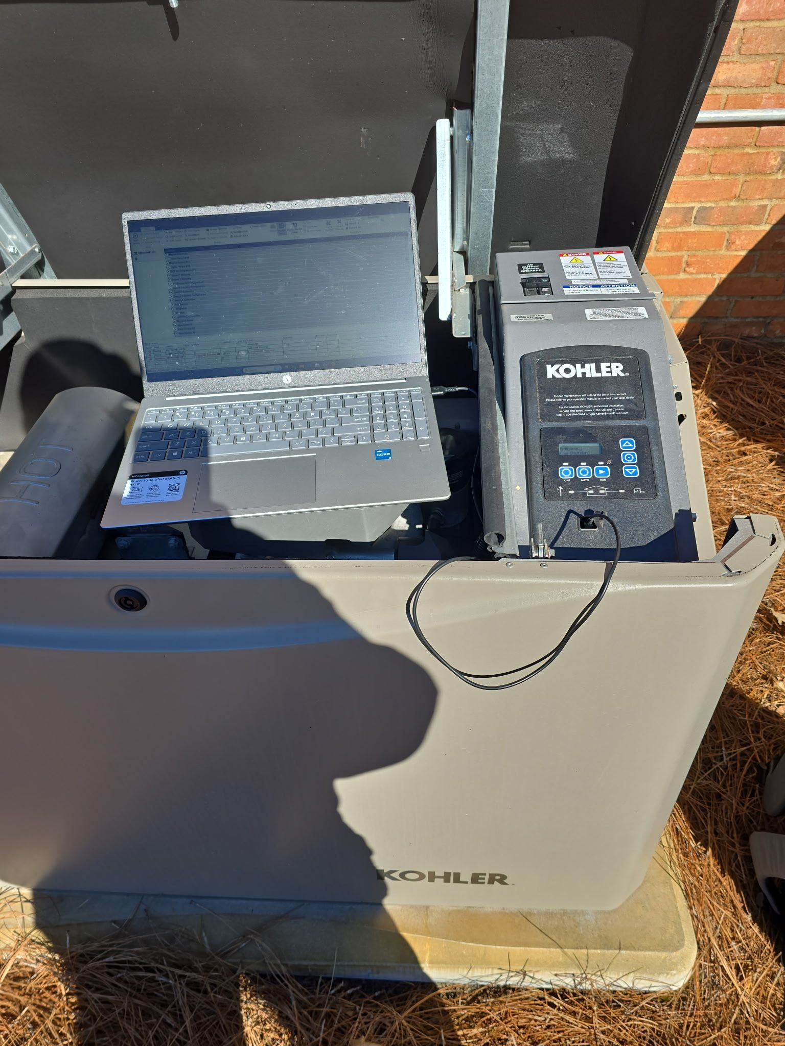 A laptop computer is sitting on top of a machine.