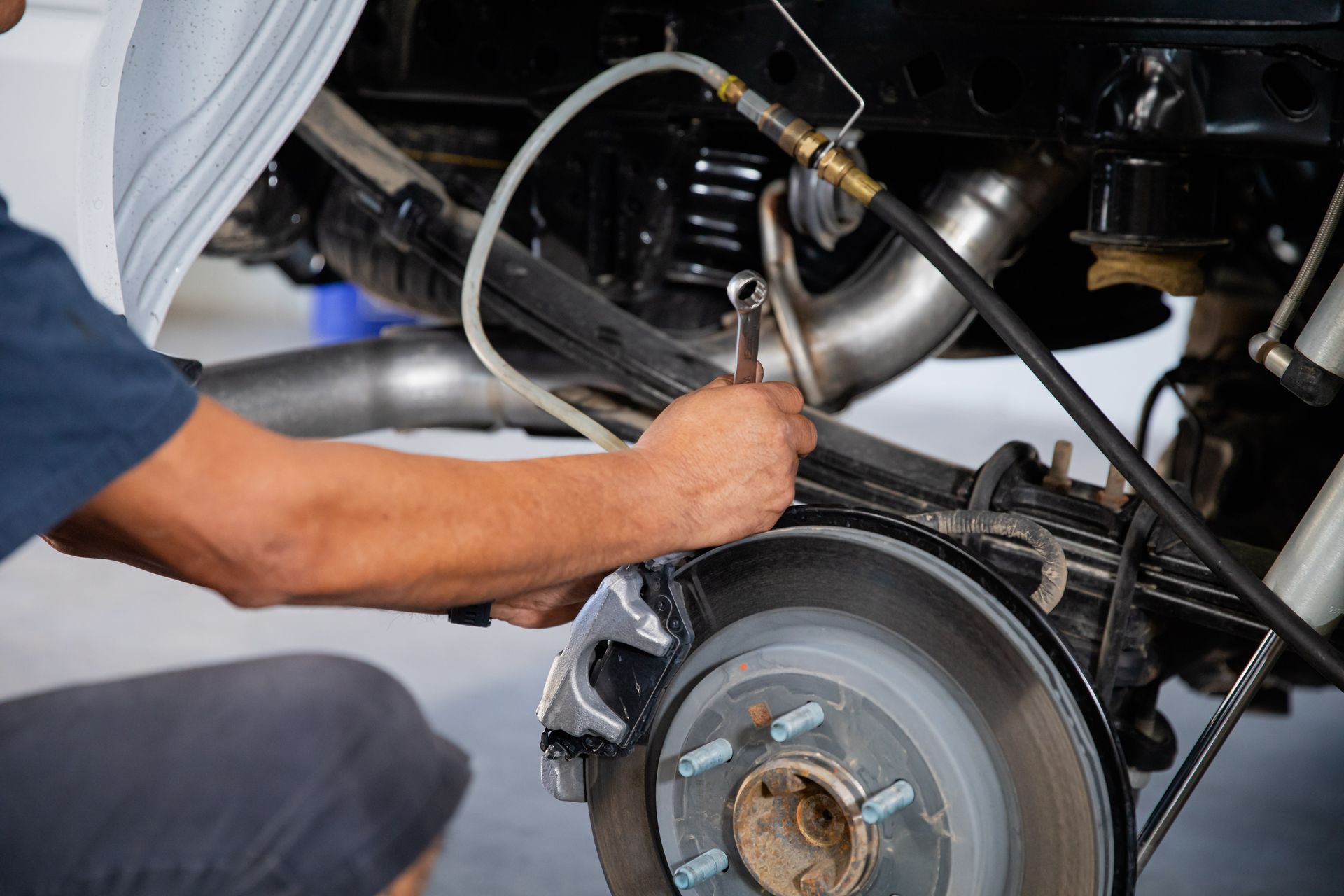A man is working on a car in a garage.