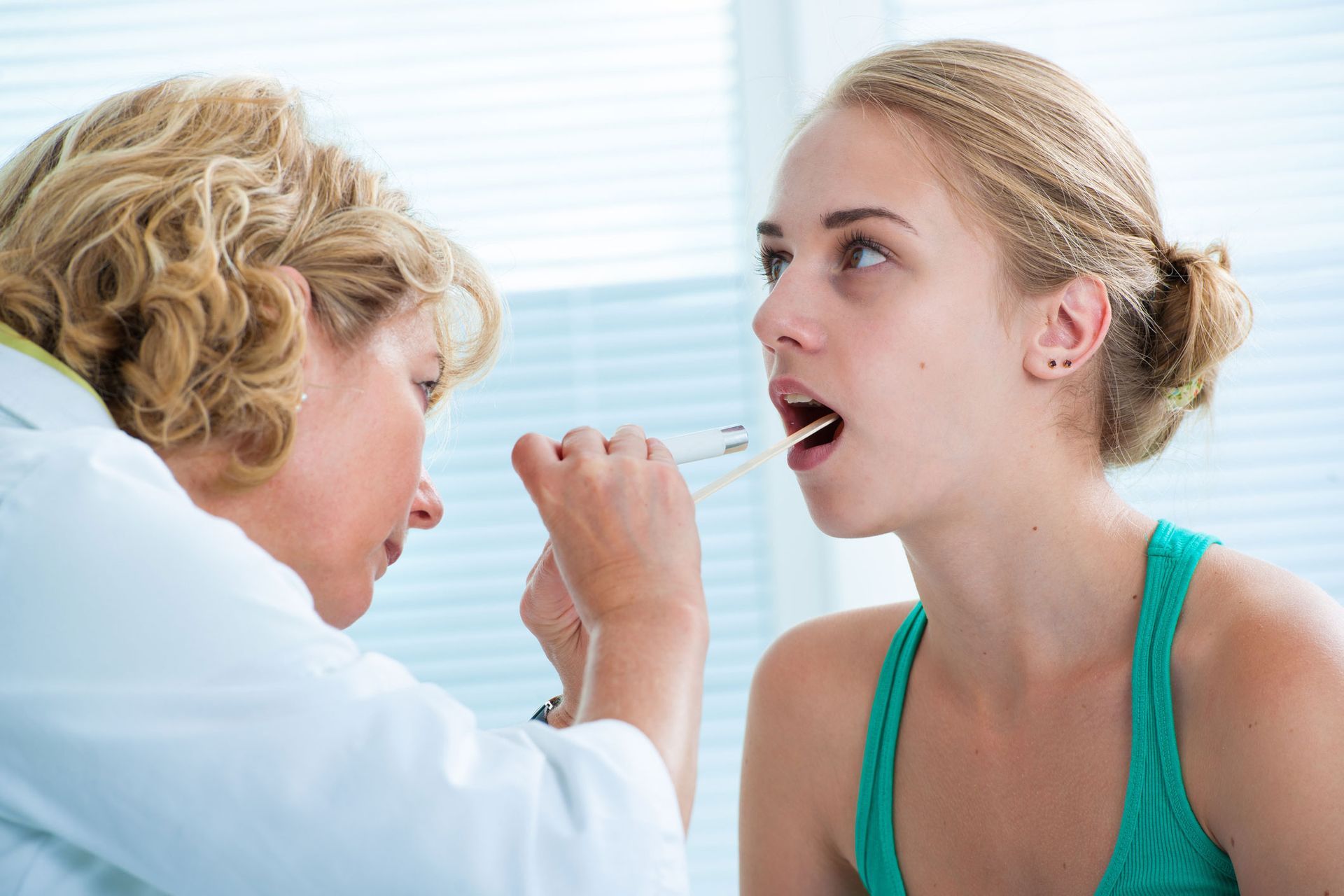 Doctor Checking Customer's Throat — Port Richey, FL — NewGen Clinical