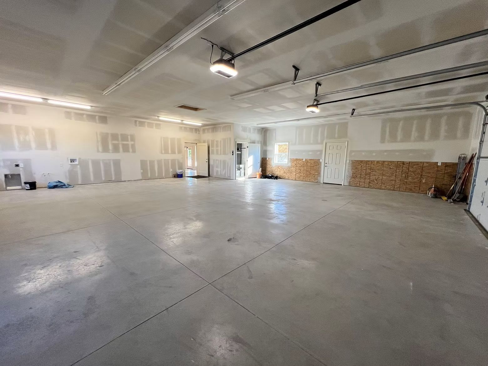 Large empty garage inside a post frame building.