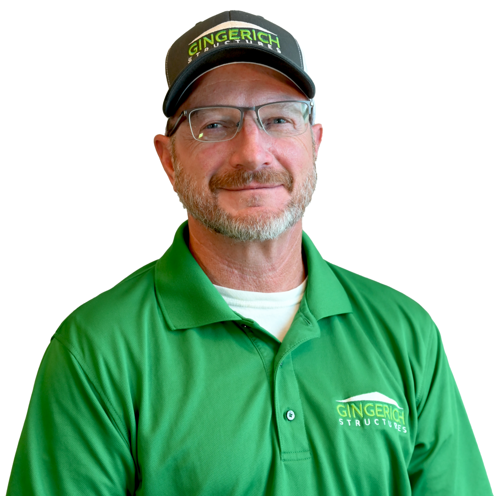 Man in green polo and hat with glasses smiling.