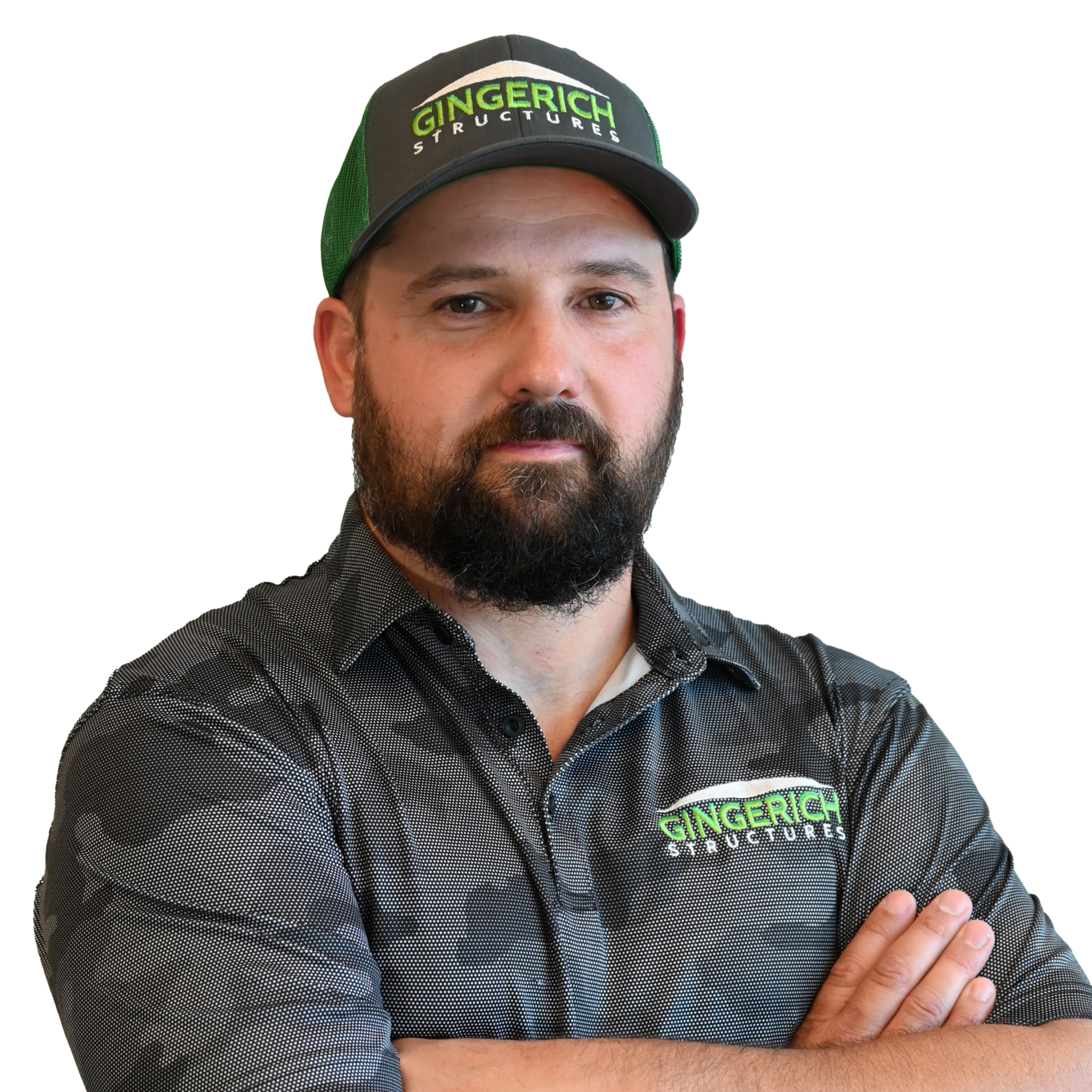 Man in cap and shirt, arms crossed, looking at the viewer. Gray cap and shirt, green accents.