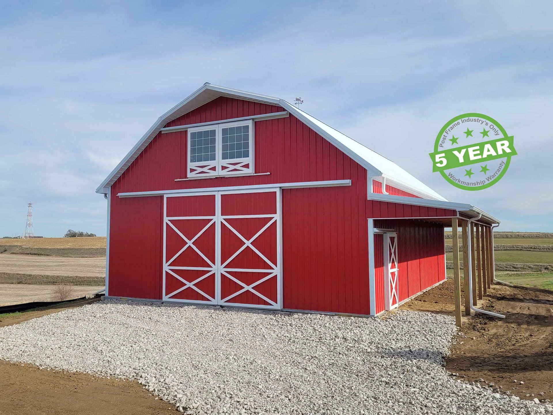 HP - 2 - RB Red barn with white trim and sliding doors, gravel path, and blue sky.