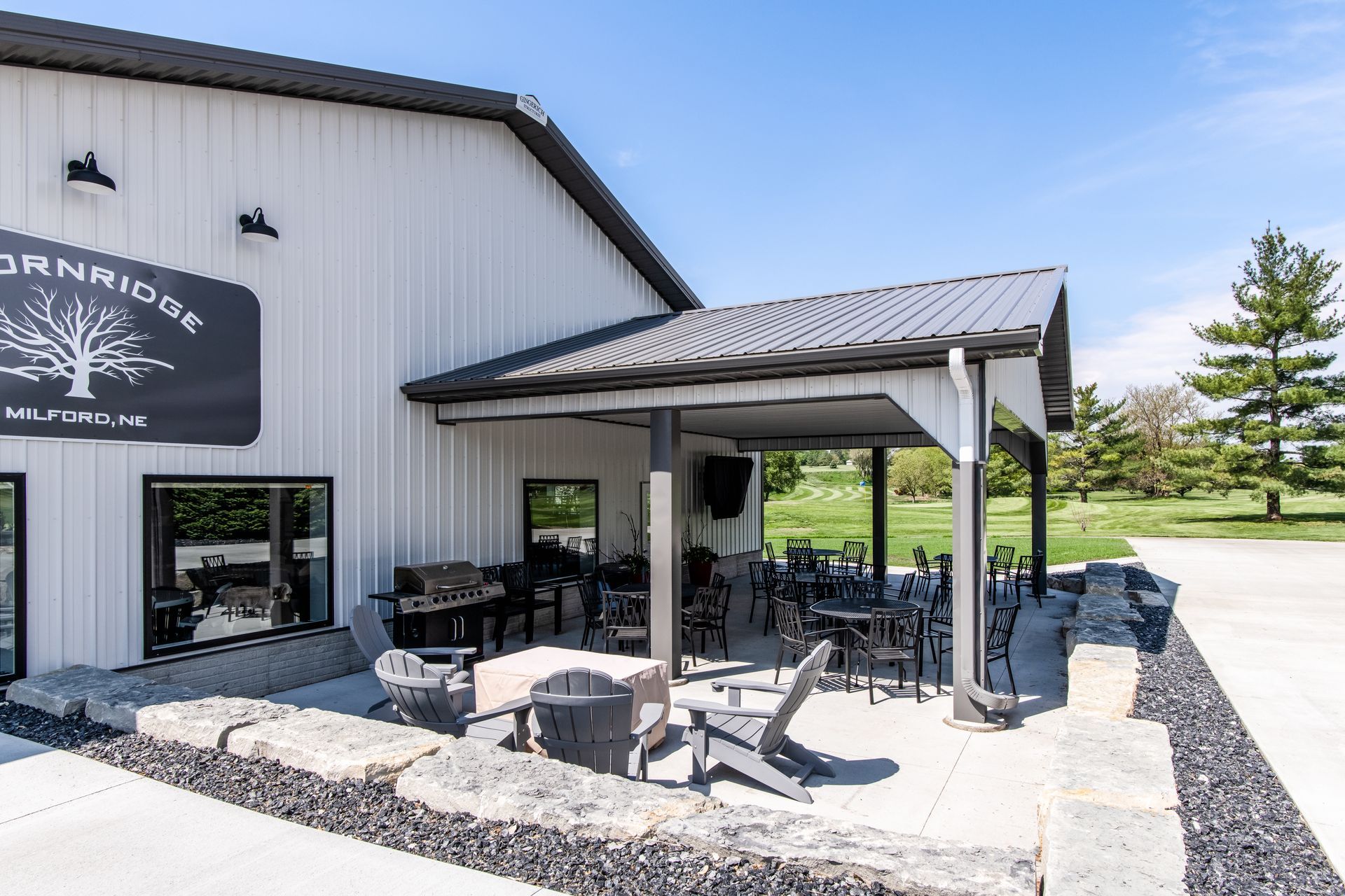 Outdoor patio at Thornridge Winery with tables, chairs, and a covered seating area.