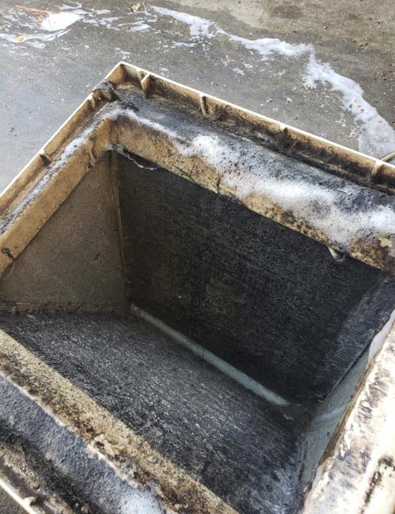 Dirty air duct with soap suds and black mold on the interior surfaces.