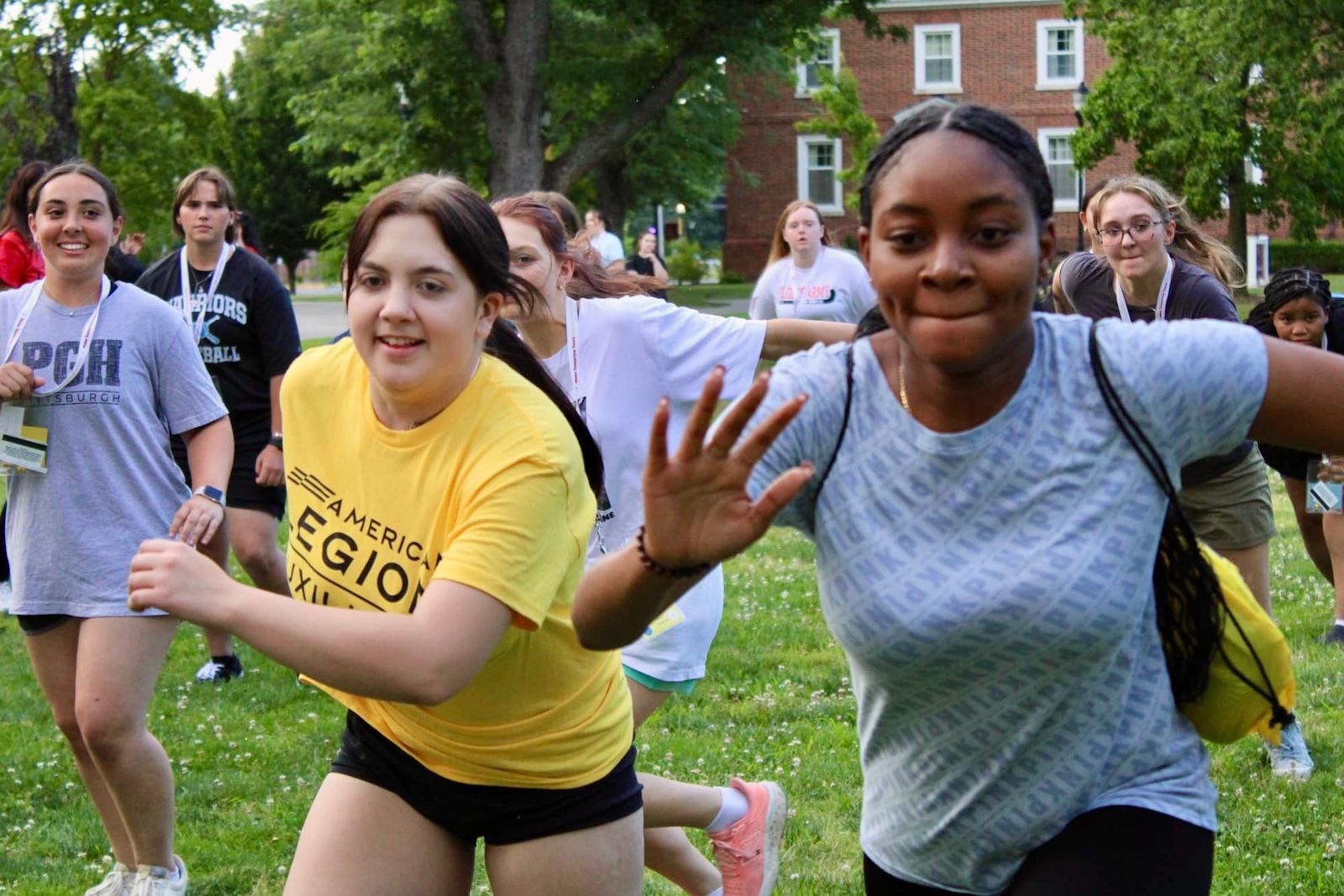 A group of young women are running in a field