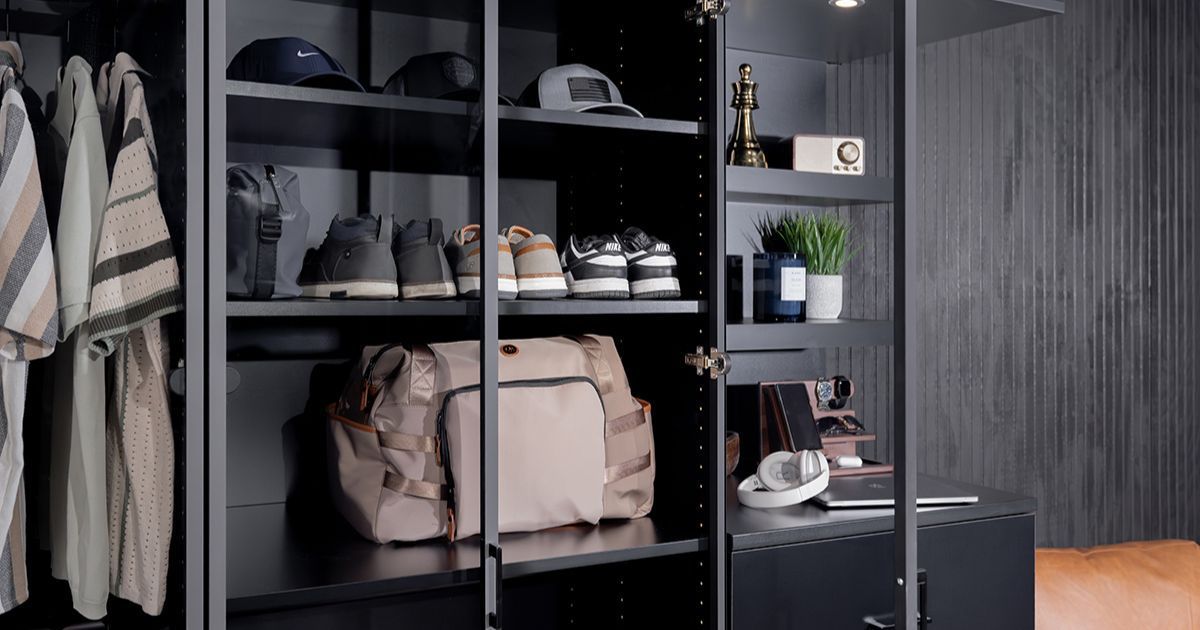 Black closet with shirts, hats, shoes, bag, and accessories.