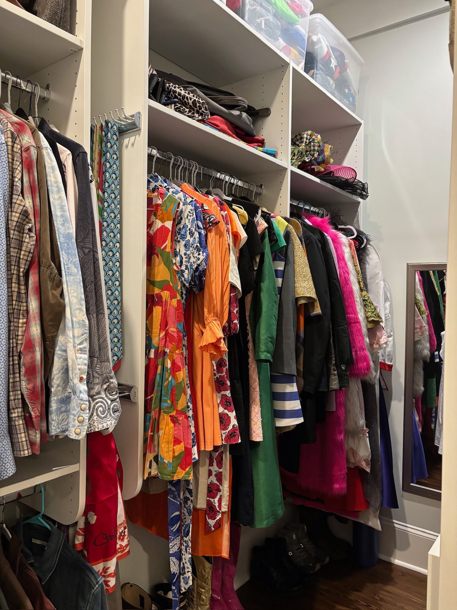 Closet filled with clothes of various colors and styles, including dresses, shirts, and jackets.
