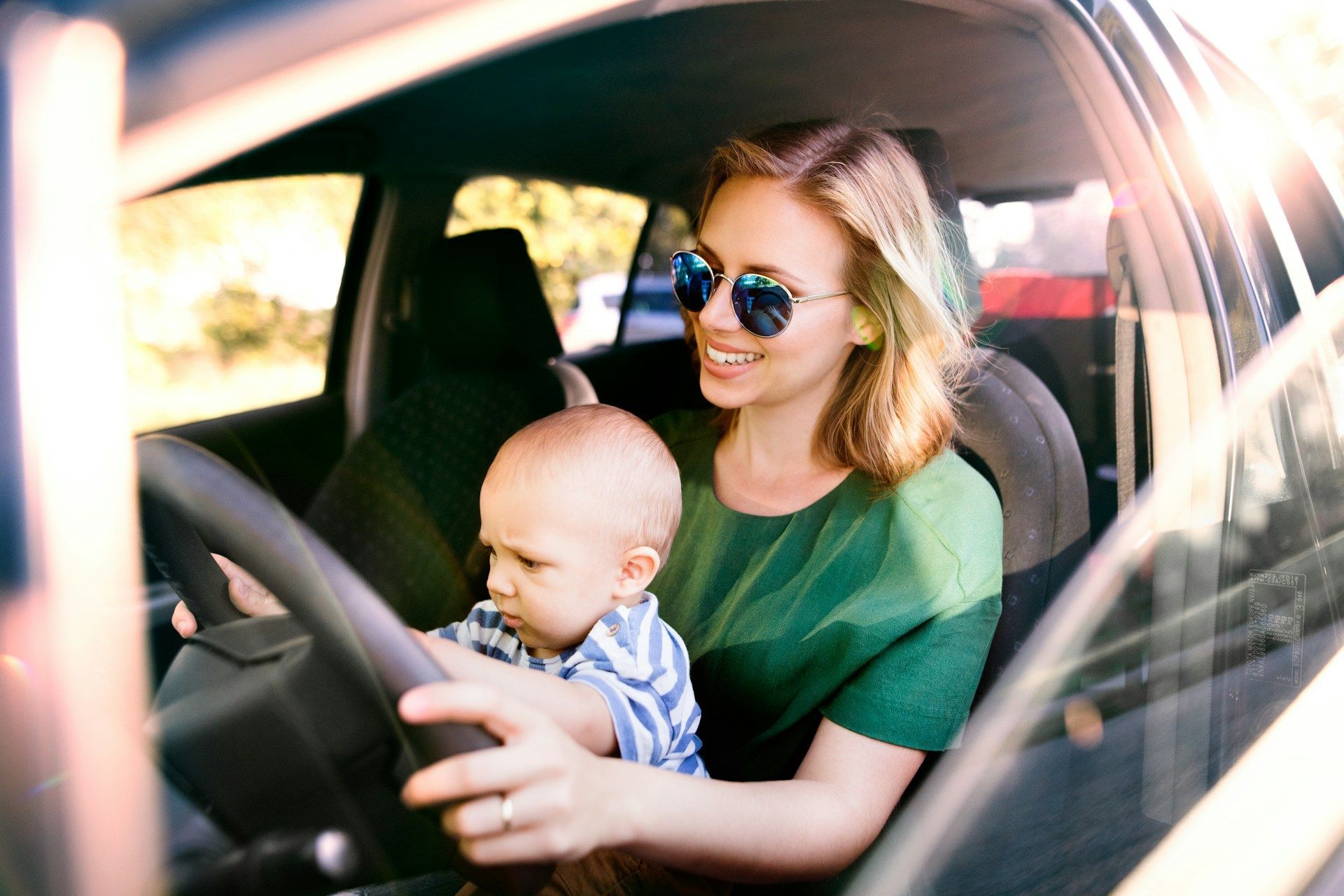 A family is sitting in the back of a car.
