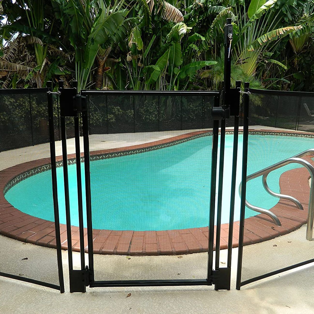 A swimming pool with a black fence around it