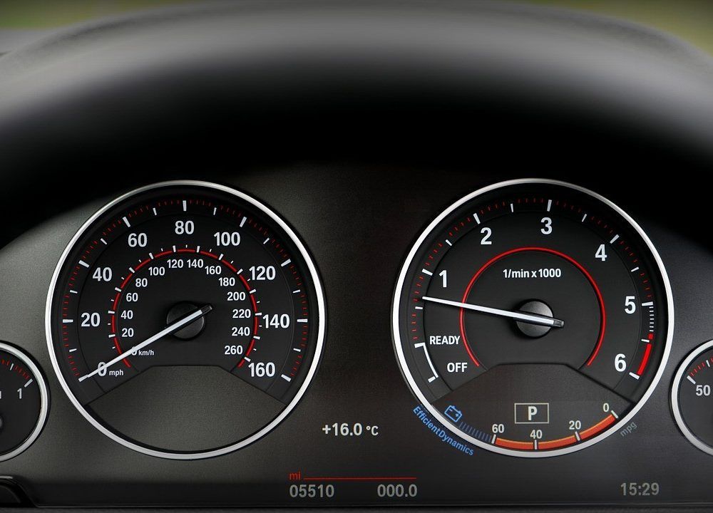 Dashboard gauges showing speed and RPM readings.