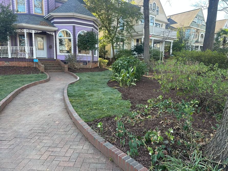 There is a brick walkway leading to a purple house.