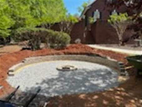 A large pond is being built in the backyard of a house.