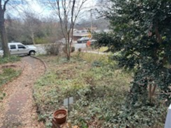 A white truck is parked in the backyard of a house.