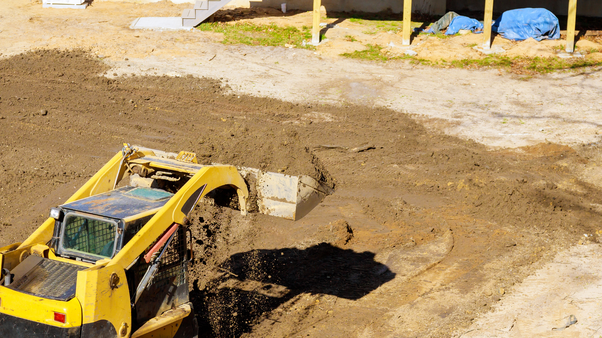 Two men are working in a garden with a shovel