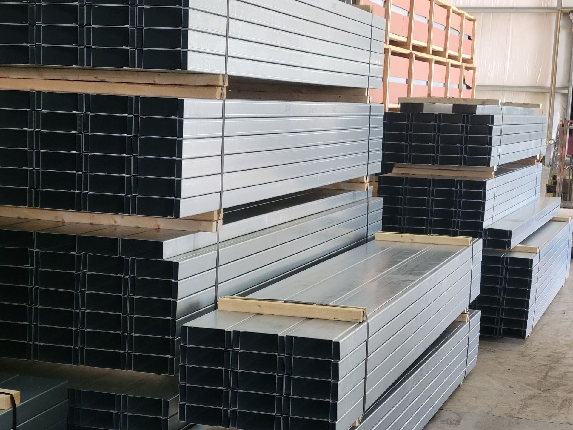 A warehouse filled with lots of metal pipes stacked on top of each other