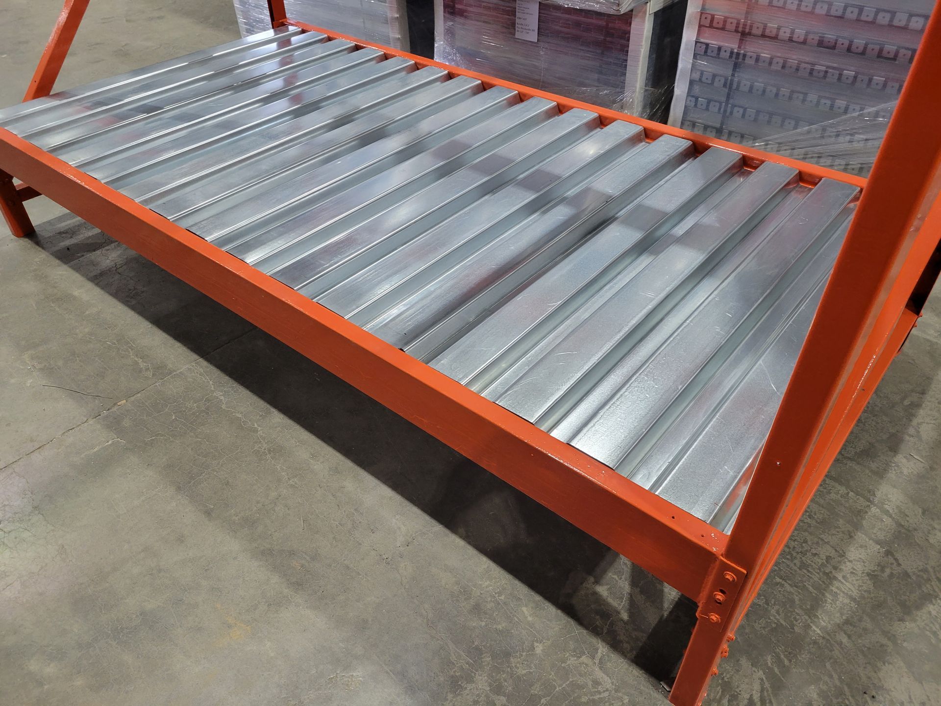 A warehouse with a lot of shelves and a lot of red shelves