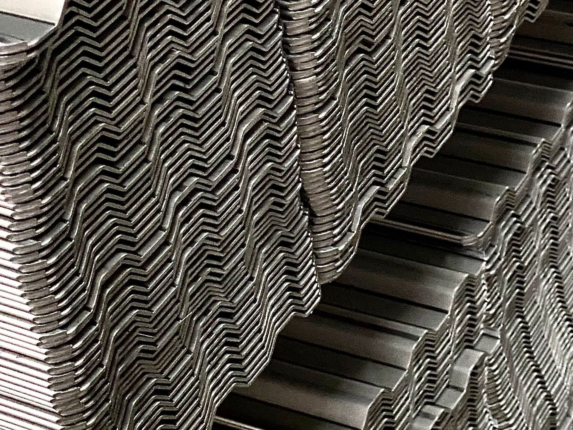 A close up of a stack of metal sheets stacked on top of each other.