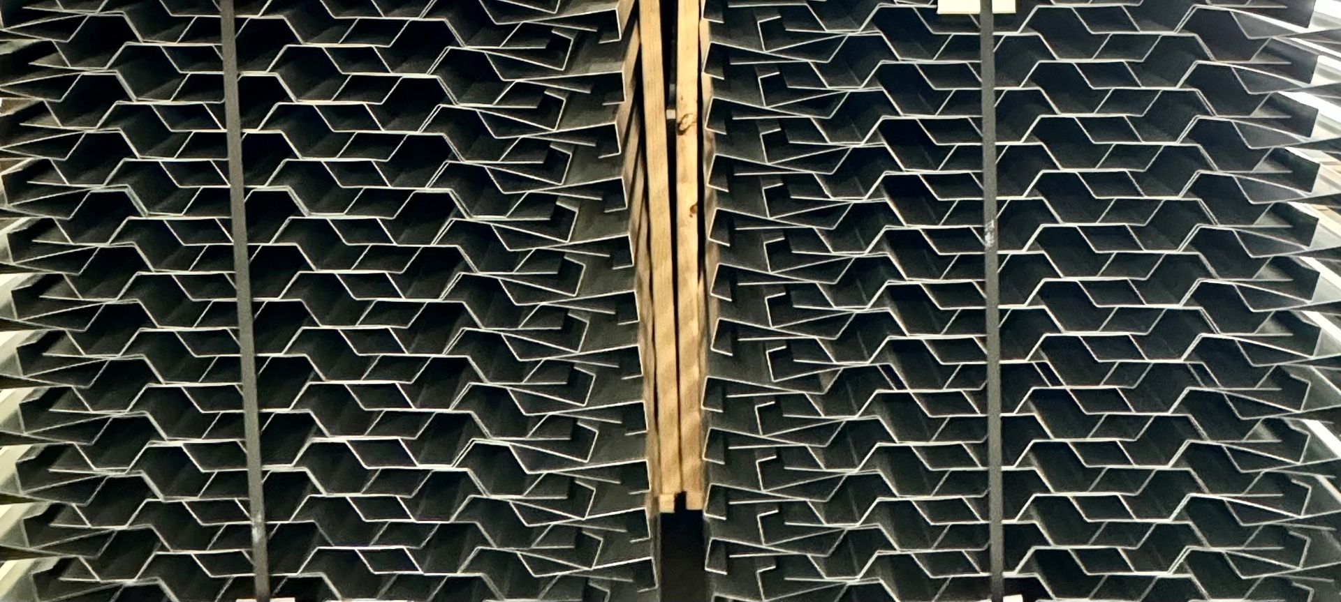 A stack of metal sheets sitting on top of a wooden pallet.