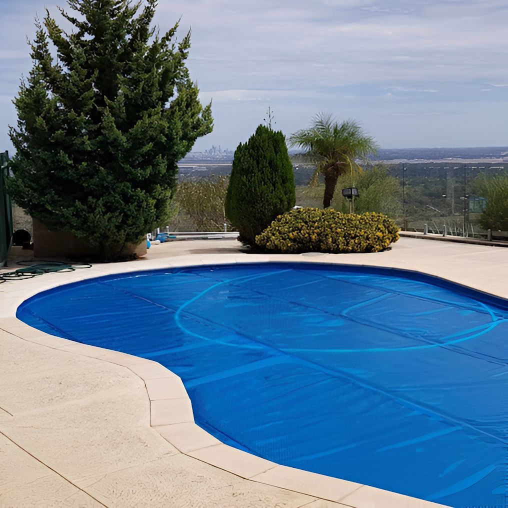 A Large Swimming Pool With a Blue Cover on It — Newcastle Solar Pool Heating Systems In Elermore Vale, NSW