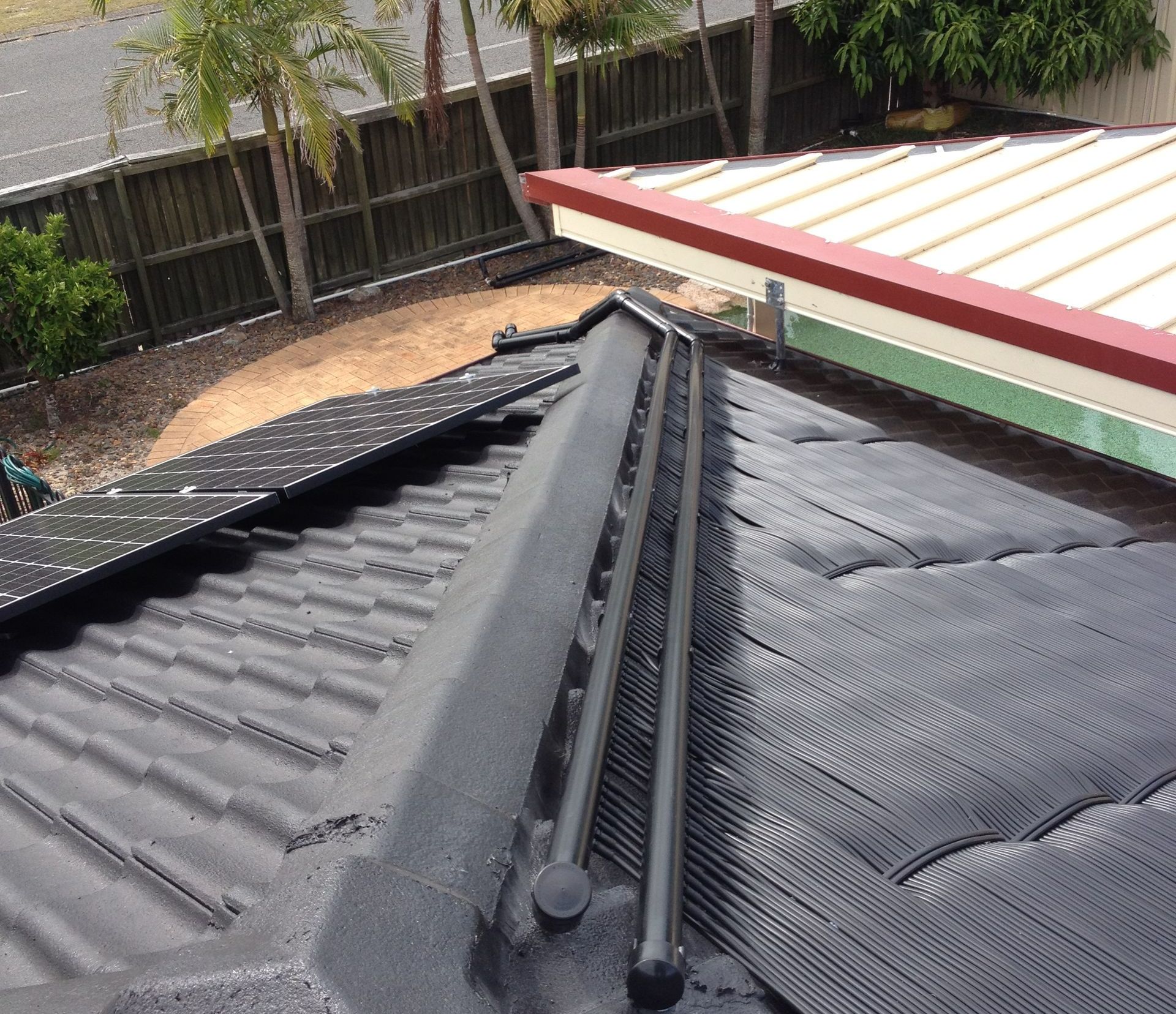 A Roof With a Few Solar Panels — Newcastle Solar Pool Heating Systems In Elermore Vale, NSW 
