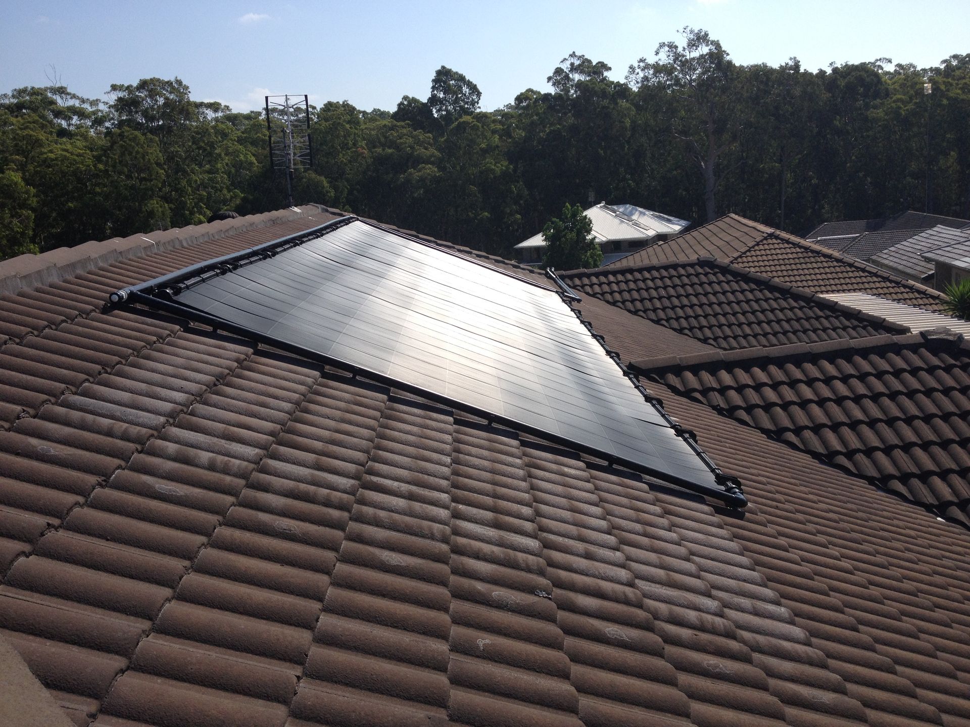 A Roof With a Triangle Shaped Solar Panel on It — Newcastle Solar Pool Heating Systems In Lake Macquarie, NSW