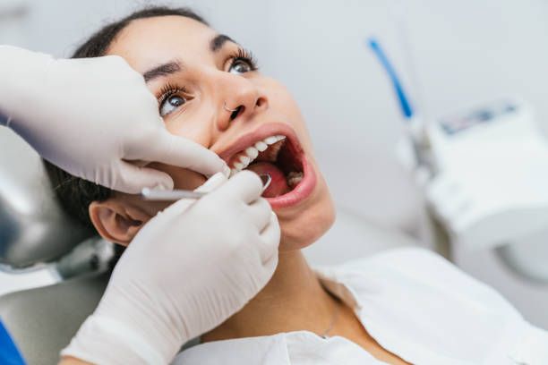 Close-up of a female patient receiving dental service.