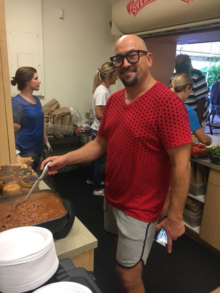 Man serving beans at the food bank. 