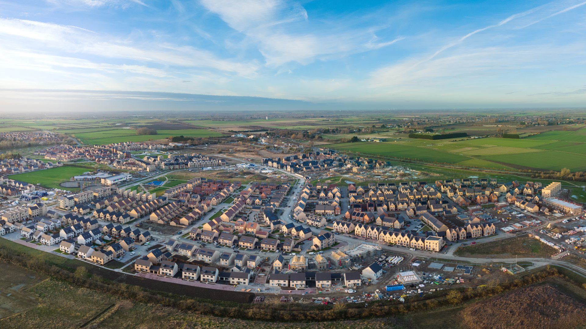 Wide angle drone photo of Northstowe on a sunny day at sunset