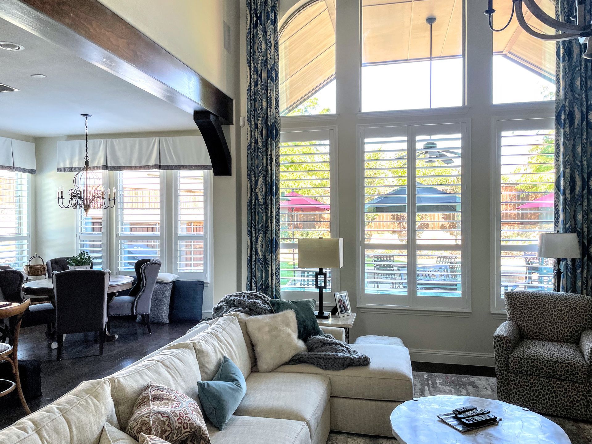 A living room with a couch , chairs , and a table.