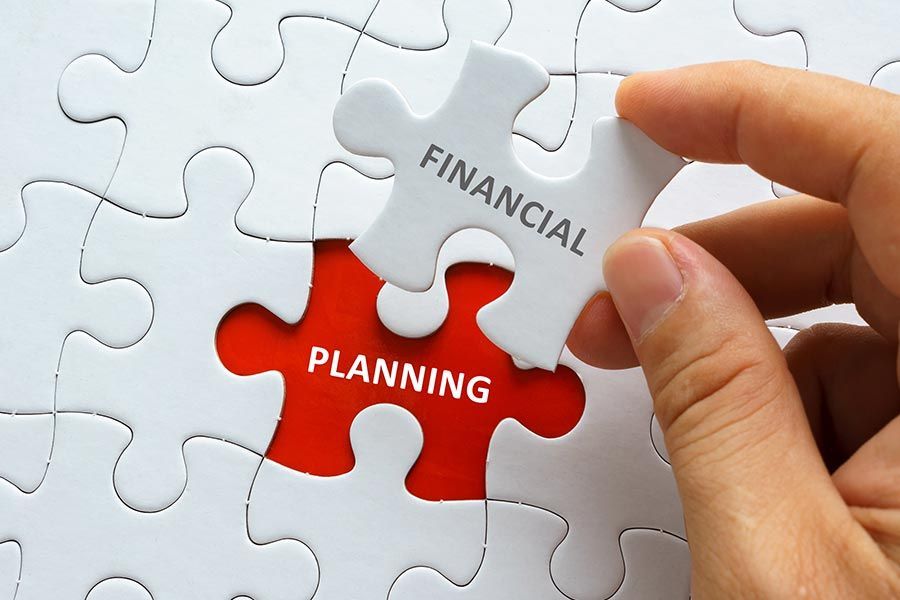 A Person is Holding a Piece of a Puzzle That Says Financial Planning — Peter Maundrell & Company Pty Ltd in Emerald, QLD