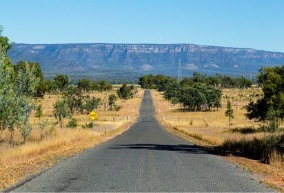 An Empty Road With a Mountain in the Background — Peter Maundrell & Company Pty Ltd in Central Highlands, QLD