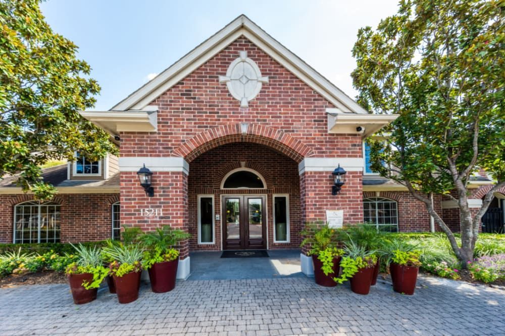 a large brick building with a clock on the top of it at Marquis on Park Row in Houston, TX.
