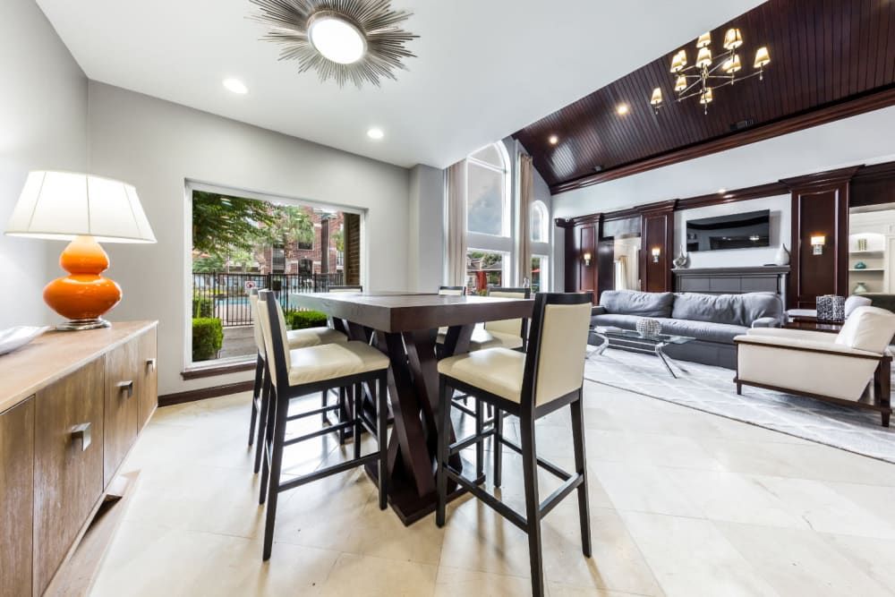 a living room with a table and chairs in it at Marquis on Park Row in Houston, TX.
