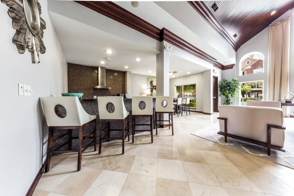 a clubhouse room with a couch and chairs in it at Marquis on Park Row in Houston, TX.