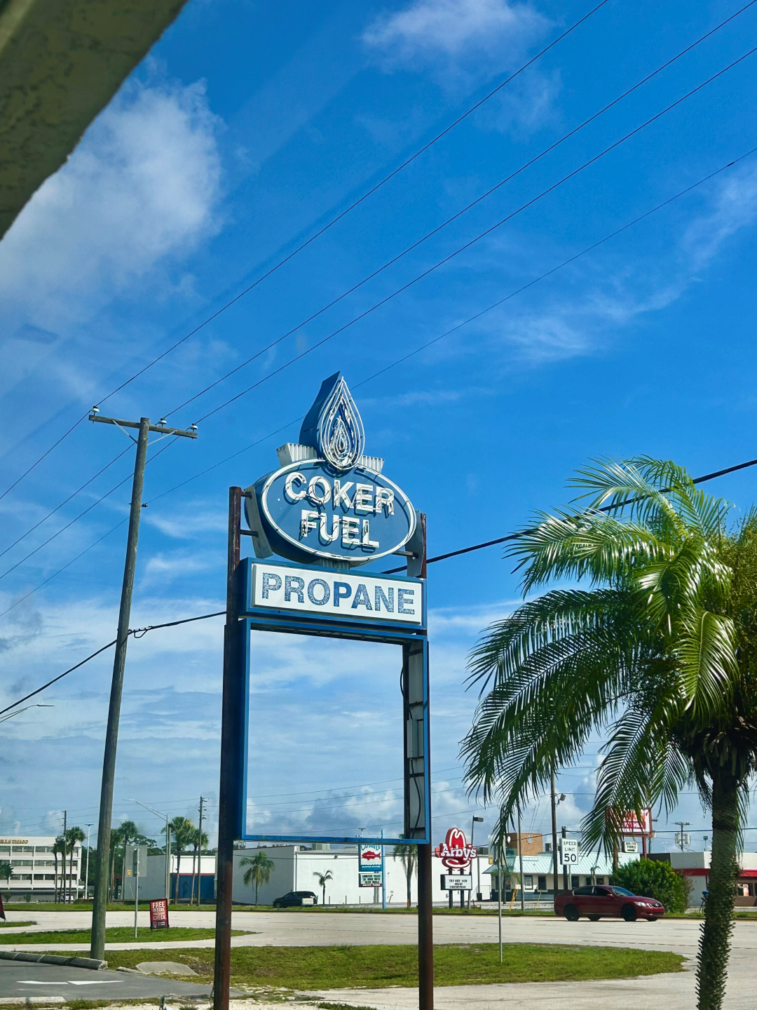 A blue sign that says Coker fuel propane on it - Coker Fuel