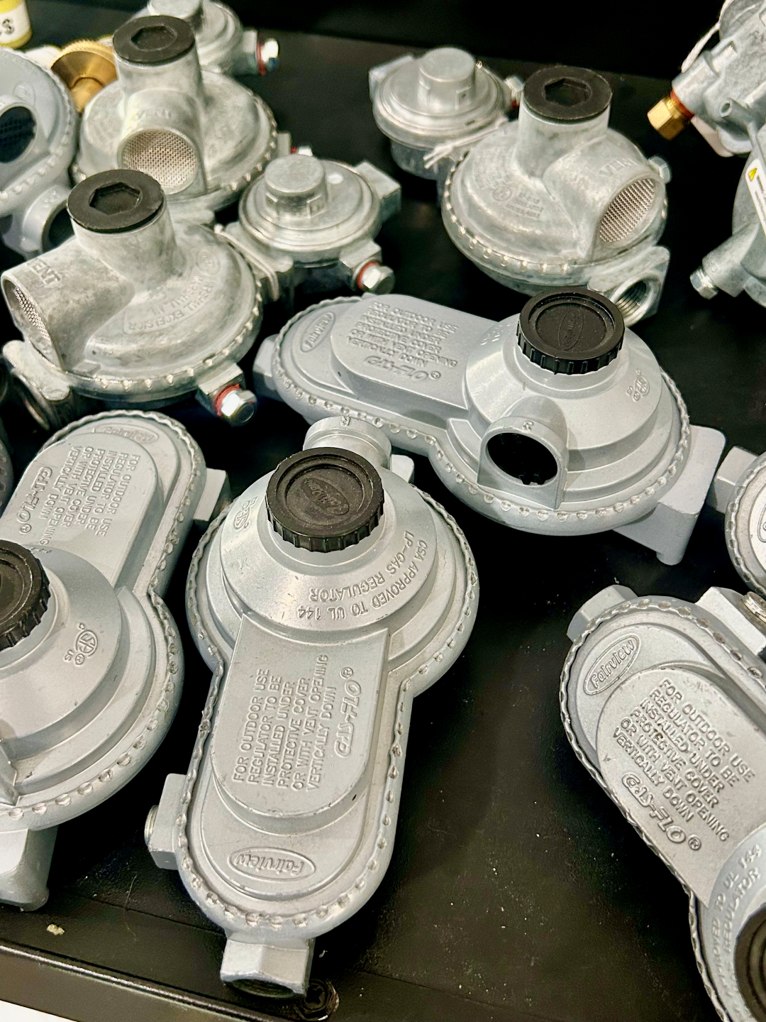 A bunch of gas valves are sitting on a table. - Coker Fuel