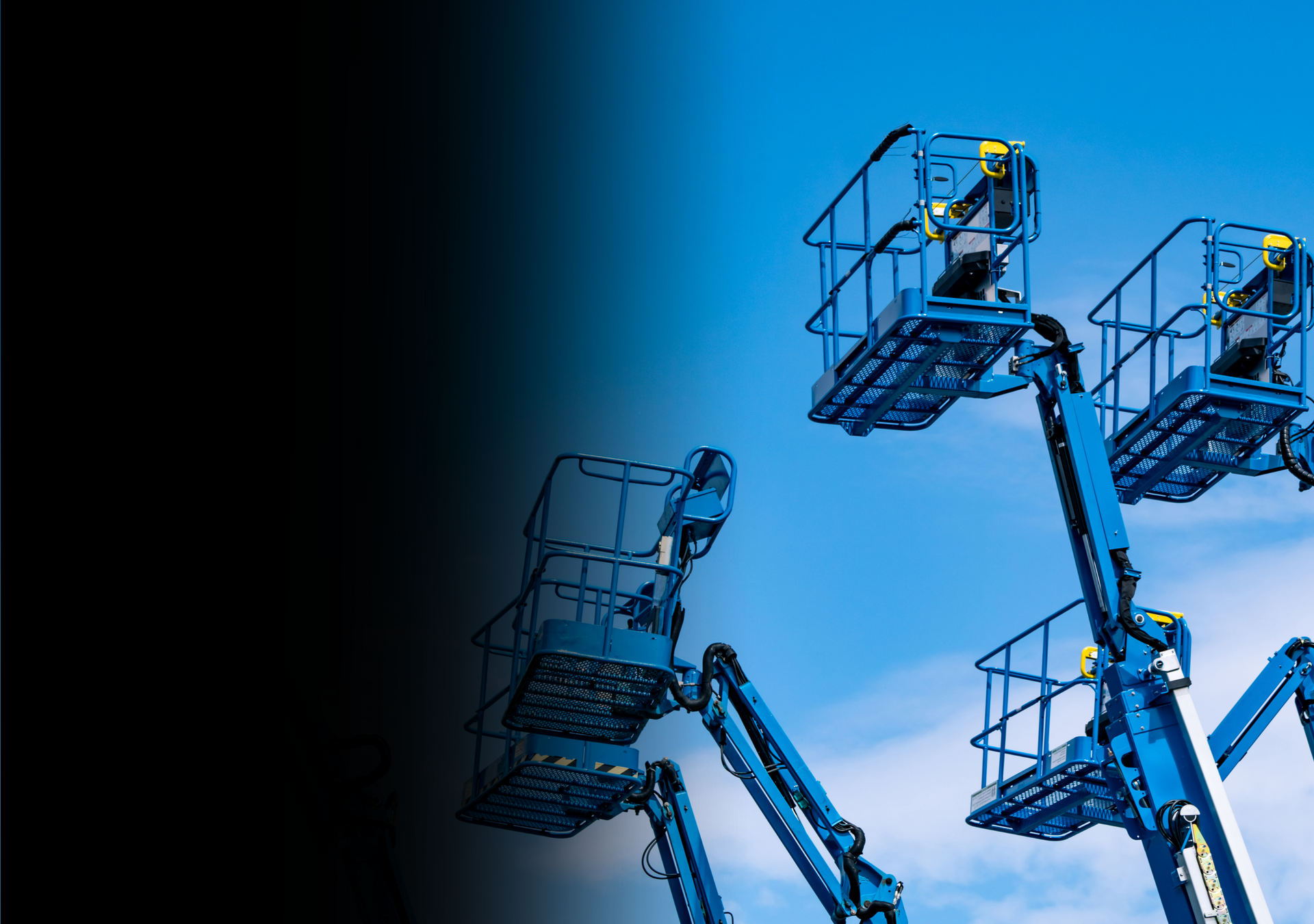 A group of blue aerial lifts against a blue sky