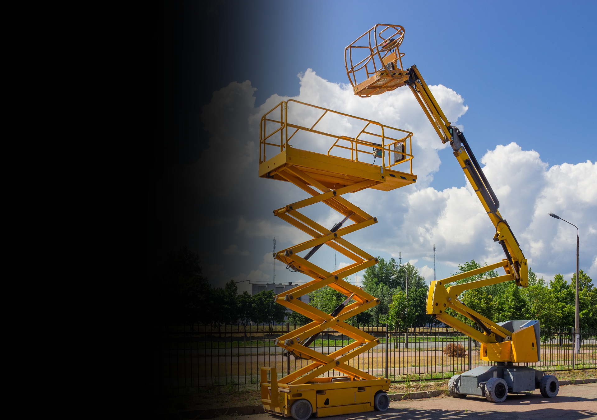 A yellow scissor lift is parked in a parking lot.