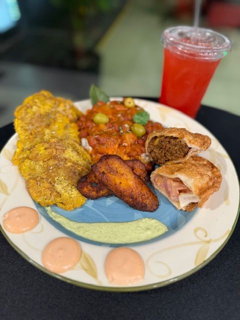 A plate of food and a drink on a table