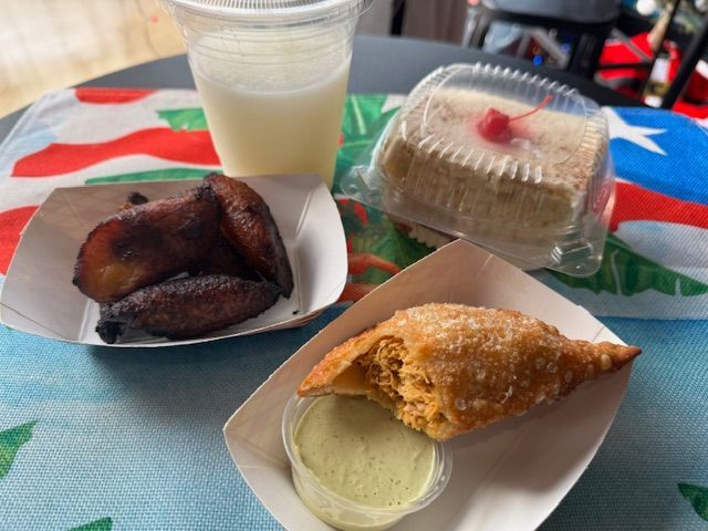 A table topped with plates of food and a drink.