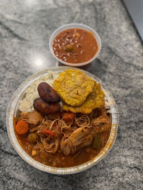 There is a bowl of beans and a bowl of rice on the table.