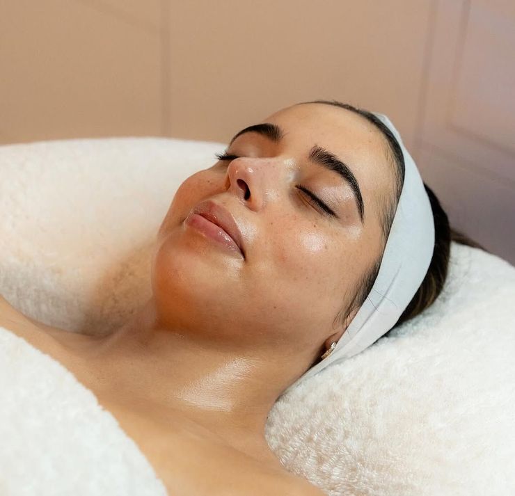 A Woman is Laying on a Bed With Her Eyes Closed — SKN Gold Coast in Southport, QLD