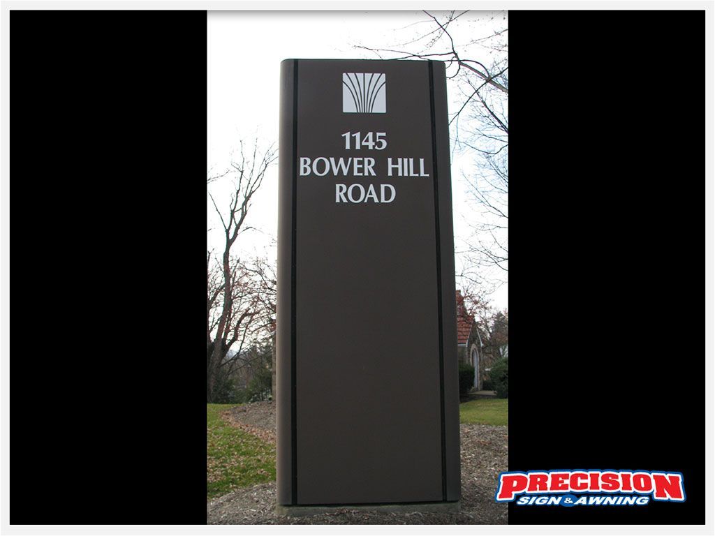 Brown street sign with white text reads