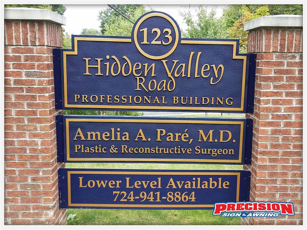 Sign for Hidden Valley Road Professional Building: Blue signs with gold lettering. Includes address, doctor's name, and phone.