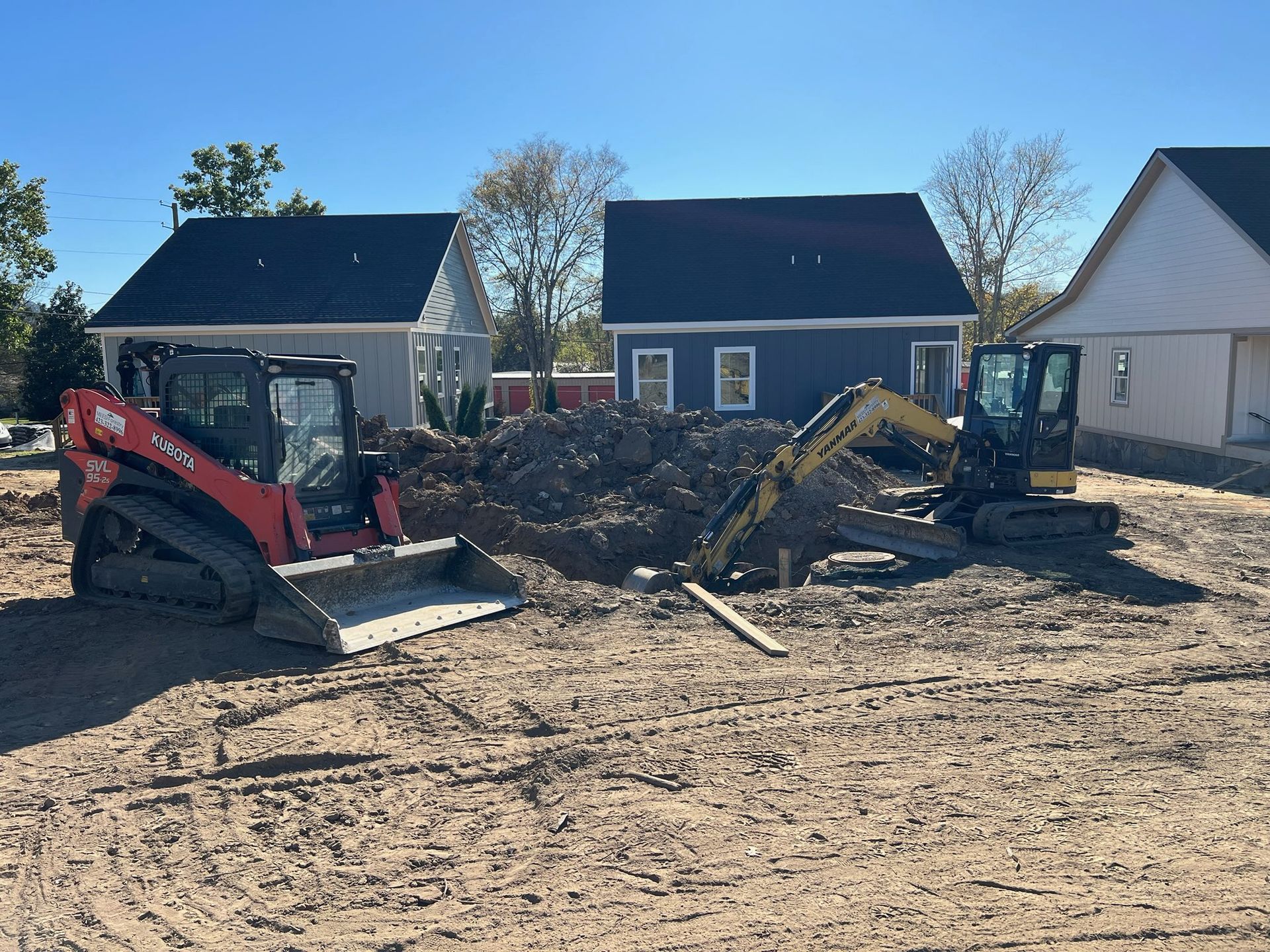 A person holding a baby up in the air indoors near a window, baby smiling.