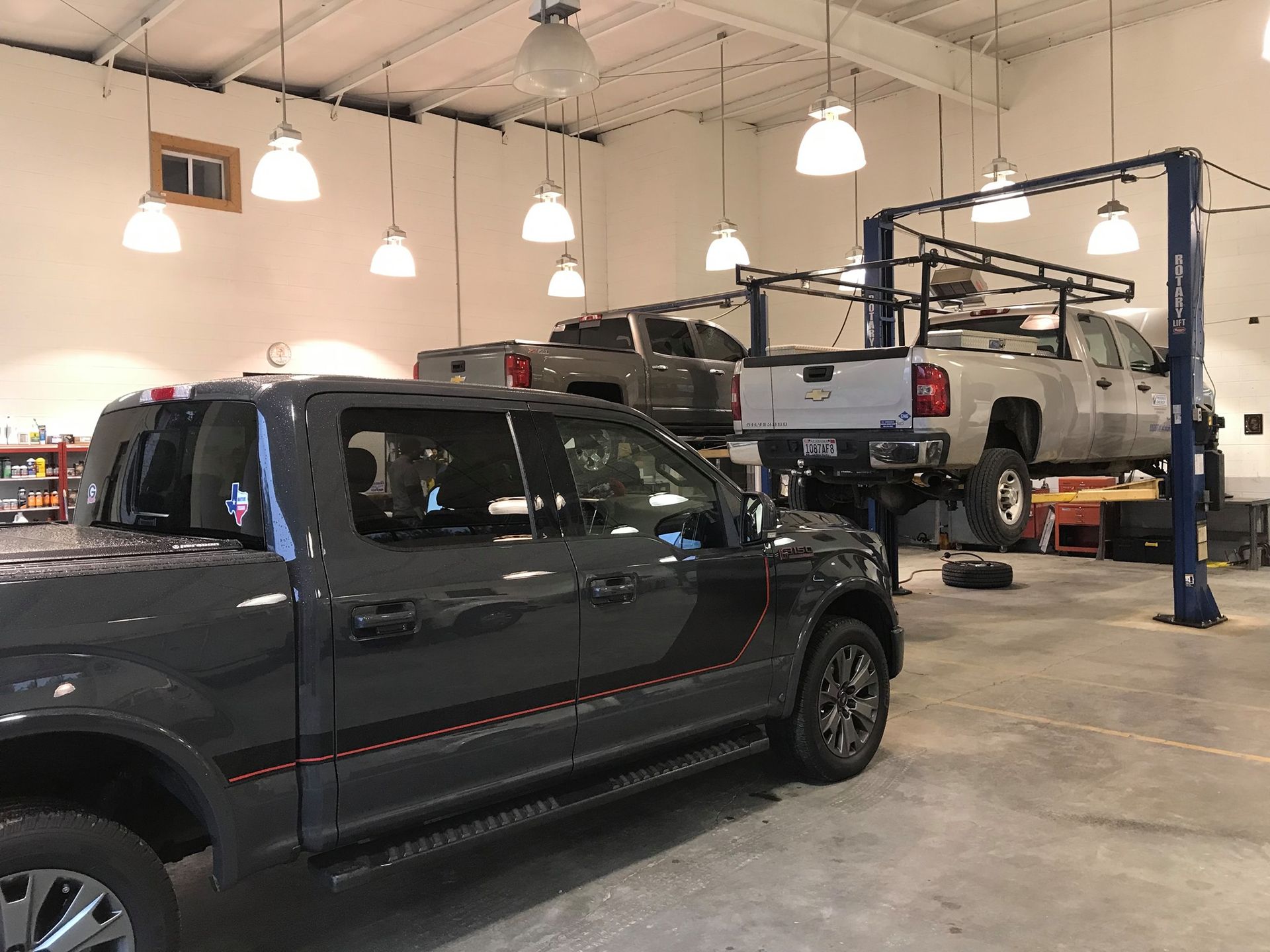 A Row of Trucks Are Parked in a Garage | Apex Vehicle Services