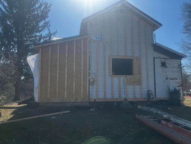 Side of a house under construction; new wood framing and insulation added.