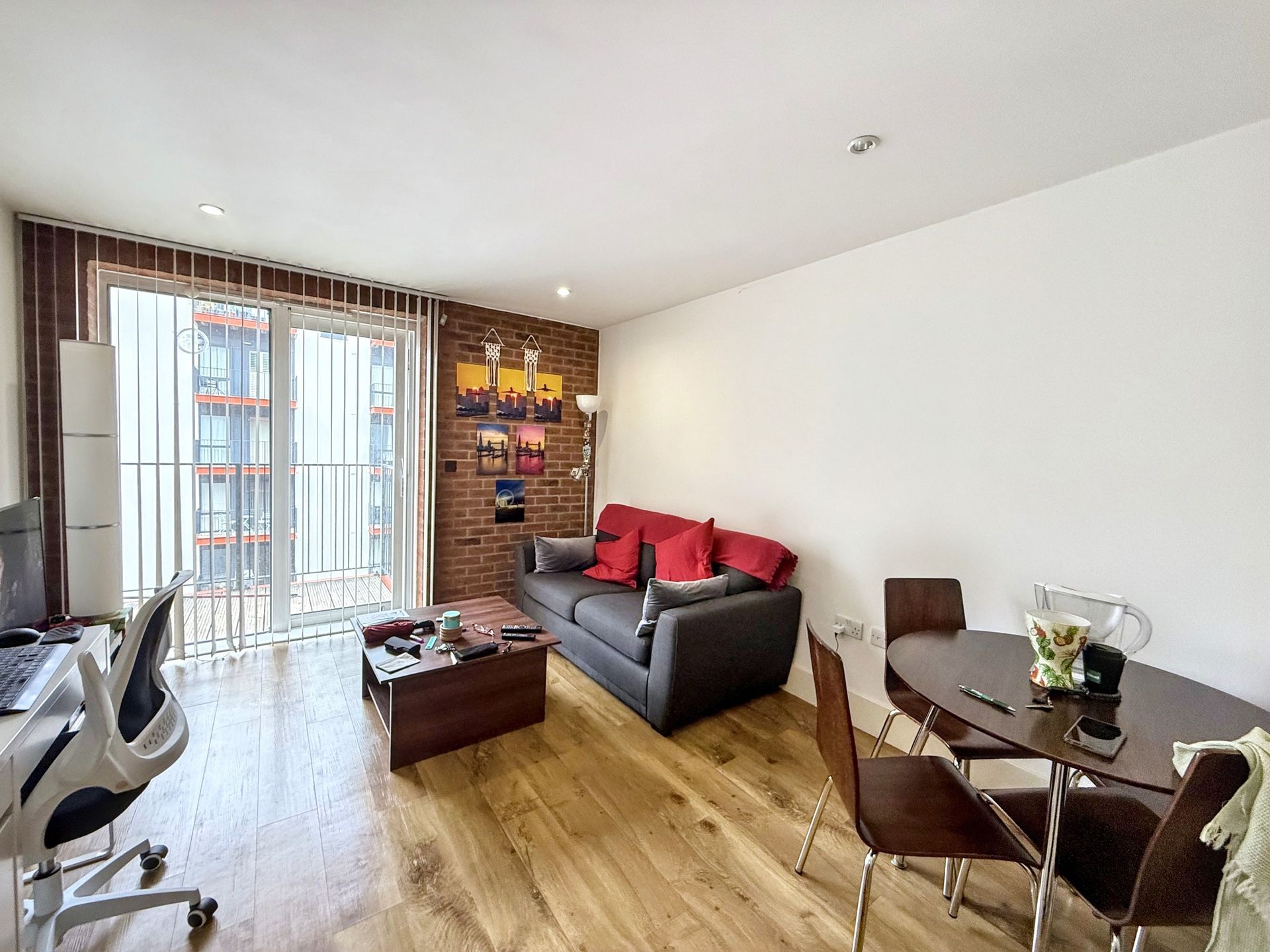A living room with a couch , table and chairs.