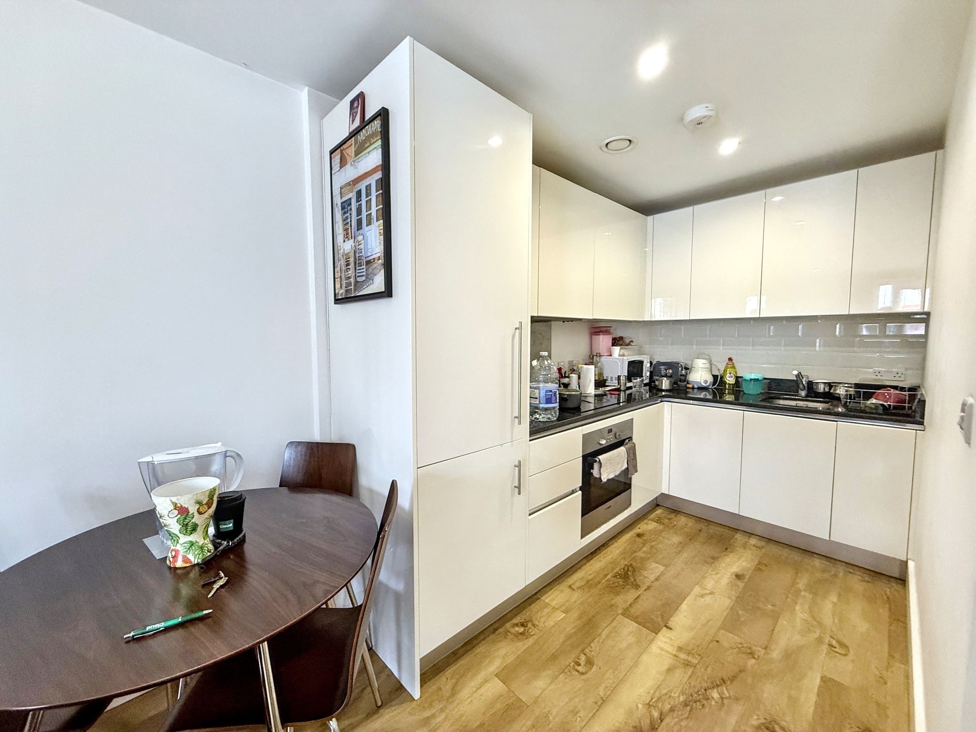 A kitchen with a table and chairs in it